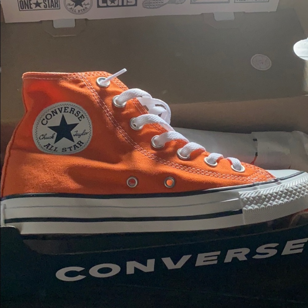 a pair of orange converse